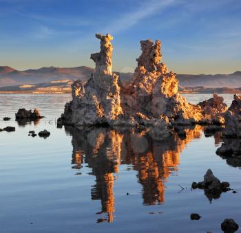   Yosemite National Park, USA. Outliers -  bizarre calcareous tufa formation  reflected in the mirrored surface of the water. The picturesque sunset at Mono Lake