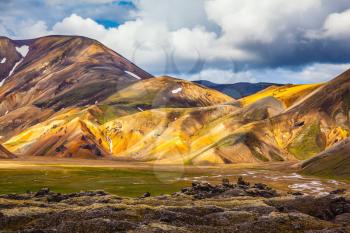 Travel to Iceland in the summer. National Park Landmannalaugar. Multicolored rhyolite mountains highlights the July sun