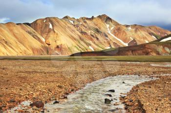  The route starts on a stream. Gorgeous orange and pink mountains. Reserve Landmannalaugar, Iceland
