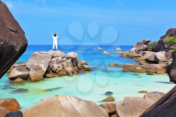 Thailand. Gorgeous beach on the Similan Islands. Middle-aged woman dressed in white doing yoga. 
Asana Blessing of the Sun