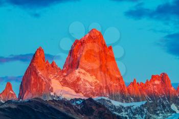 Sharp tops fantastically beautiful cliffs Fitz Roy illuminates the crimson sunset. Amazing Patagonia in February