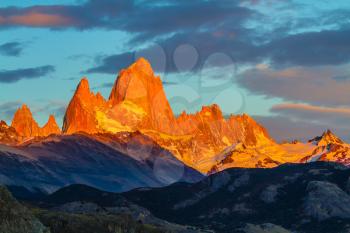 Blood-red sunset illuminates the top of impressive cliffs Fitz Roy. Fantastic Patagonia