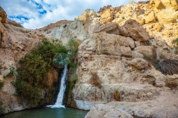  The journey through the national park and reserves Ein Gedi, Israel. Adorable waterfall among rocks parched desert