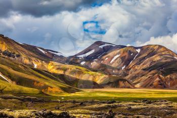 Valley National Park Landmannalaugar. On the gentle slopes of the mountains are snow fields and glaciers. Magnificent Iceland in the summer