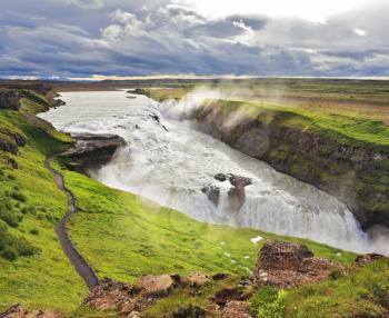 Water abyss. Enormous waterfall Gyullfoss. Summer in Iceland