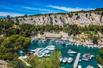 Graceful sailing yachts in the deep sea gulf. The picturesque fjord with turquoise water at coast of the Mediterranean Sea. National park of Calanques in Provence, between Marseille and Kassis