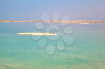The shoaled Dead Sea at coast of Israel. The condensed salt out over water surface