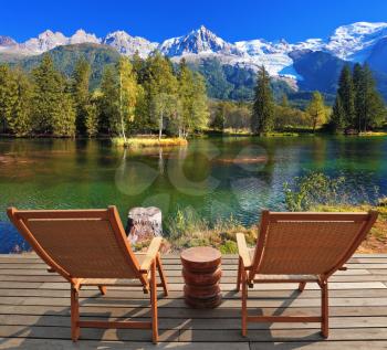 City park in the Alpine resort of Chamonix. Comfortable lounge chairs on wooden platform for rest and observation