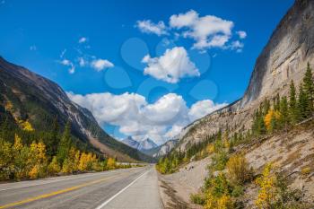 Highway in Banff National Park. Magnificent mountains lit afternoon sun. Canada, Alberta, Rocky Mountains