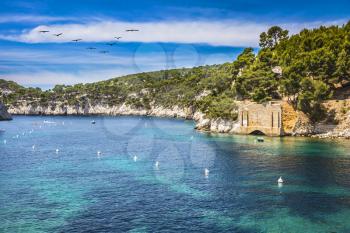  Abrupt stony coast and turquoise sea surface. Famous National Park Calanques on the Mediterranean coast. Provence, France, spring
