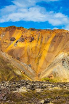 Summer volcanic tundra.  Travel to Iceland in the July. Incredible shades of rhyolitic mountains - yellow, orange, green and blue
