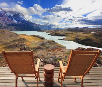 Wooden chairs in the Chilean national park Torres del Paine. Pleasant holiday