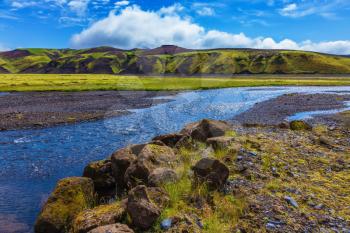  Picturesque basalt hills overgrown green grass and moss. On bottom of canyon many streams flow. Canyon Pakgil in Iceland