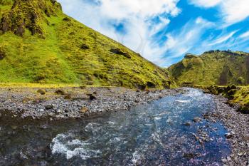 The canyon Pakgil fast flowing shallow stream. Scenic summer Iceland. The photo was taken Fisheye lens
