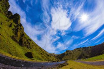Summer blooming Iceland. Camping in valley of canyon Pakgil. The canyon flowing fast shallow creek. The photo was taken Fisheye lens