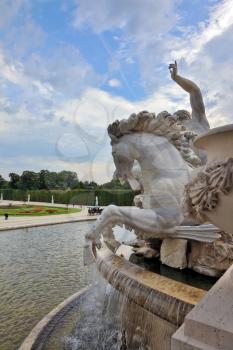 Schönbrunn - the summer residence of the Austrian Habsburg emperors. Elegant fountain and a white marble statue of a horse