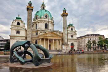 VIENNA, AUSTRIA - SEPTEMBER 26, 2013: The Church of St. Charles Borromeo. On the square in front of the church in large pond sculpture in the Art Nouveau style