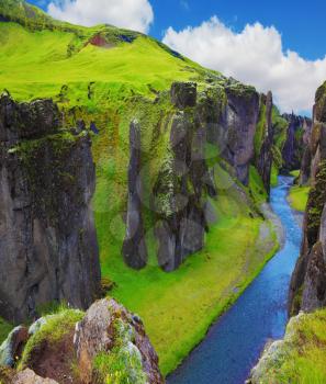 Fantastic country Iceland. The most picturesque canyon Fjadrargljufur  and the shallow creek, which flows along the bottom of the canyon