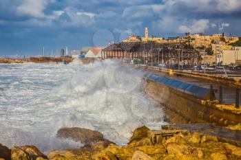 New Quay in the Old Jaffa, Israel. Whole gale in the Mediterranean Sea. Huge foamy waves fight about the coast