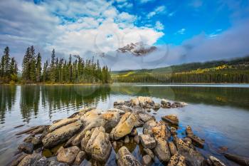 Small island in Lake Pyramid. Cold autumn day in the Canadian Rockies. The concept of tourism and vacation