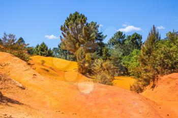 The  mining ocher quarry. Orange and red picturesque hills. Languedoc - Roussillon, Provence, France