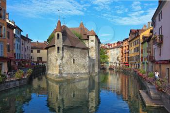 The charming ancient city of  Annecy in Provence. Clear early morning. The bastion turned into prison, is reflected in channel water