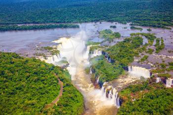  Iguazu River spreads widely among the dense tropical forests. Devil's Throat - largest waterfall of the Iguazu Falls. Picture taken from a helicopter