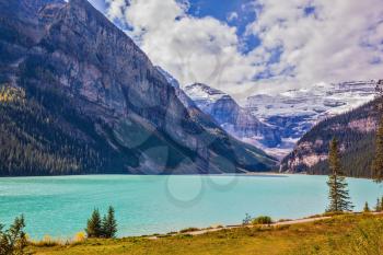 Magnificent Lake Louise is surrounded by mountain and glaciers. Rocky Mountains, Canada, Banff National Park. Great sunny day