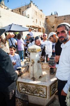 JERUSALEM, ISRAEL - OCTOBER 12, 2014:  Morning autumn Sukkot, Blessing of the Kohanim. The area in front of Western Wall of Temple filled with people. Ritual washing of hands