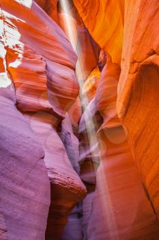 Magic sunbeam in multi-colored slot-hole Antelope canyon. The Navajo reservation, Arizona, USA