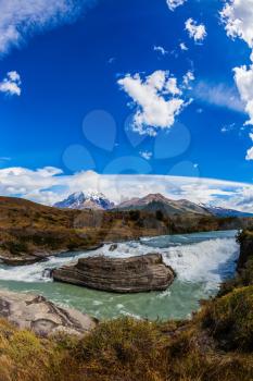  Chile, Patagonia, Torres del Paine National Park - Biosphere Reserve. Cascades Paine. Cold emerald water of the river Paine with a roar there pass rocky barriers