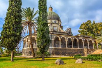 Israel, the shores of Lake Kinneret. Catholic monastery and a small church Mount of Beatitudes. Beautiful park of cypress and palm trees