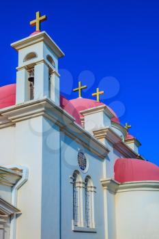 Greek church of the Cathedral of the twelve apostles. Pink domes and golden crosses crowned with snow-white church building