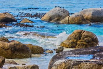 The concept of ecotourism. Huge boulders on the beach of the Atlantic Ocean. Boulders Penguin Colony in the Table Mountain National Park, South Africa