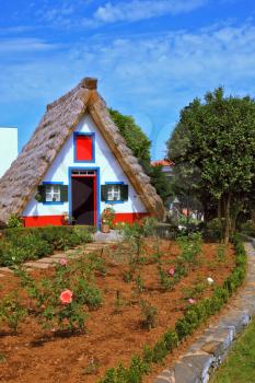 Charming rural house. Thatched house with a gable roof, two small windows and a front garden