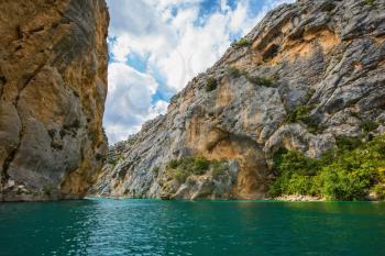 The rocky slopes of canyon Verdon descend into azure water of the river. Mercantour National Park, Provence
