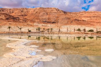 Decrease in water level in the Dead Sea. The evaporated salt acts over a water surface beautiful patterns