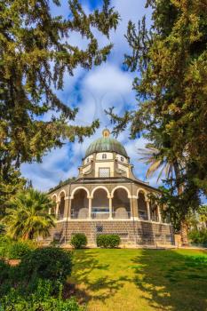 Dome and colonnade surrounded by a park. Catholic monastery and a small church Mount Beatitudes. Israel, Sea of Galilee Beach