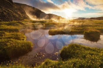 Sunrise Park Landmannalaugar. White nights in Iceland. Above the source of thermal water steam rises