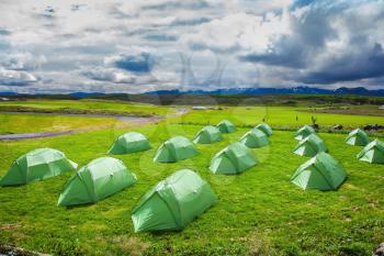 Campground in Iceland. Green tent on a grassy lawn. 