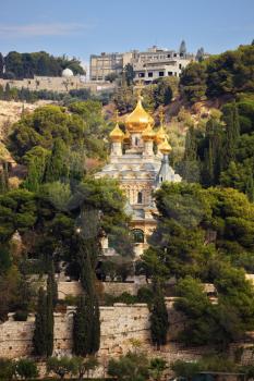 Orthodox Church of Mary Magdalene in Jerusalem. Golden domes topped with a gold cross in the green park