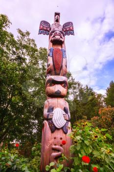 Huge Indian totemic column. Scenic decorative park Butchart Gardens on Vancouver Island