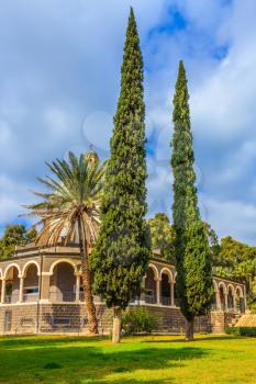 Israel, the shores of Lake Kinneret. Catholic monastery and a small church Mount Beatitudes. Dome and colonnade surrounded by cypress