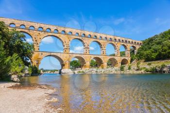 Aqueduct Pont du Gard - the highest in Europe. The bridge was built on the river Gardon in Provence. France, spring sunny day