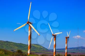 Israel. Some huge modern windmills. The blossoming Golan heights in a sunny day