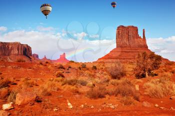 Navajo Reservation in Arizona and Utah. Stone desert and rocks - mitts of red sandstone. Fly over the valley huge balloons