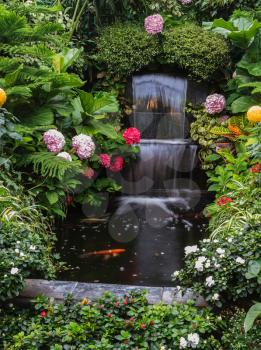  Butchart Garden Park on Vancouver Island, Canada. Gorgeous three-stage fountain surrounded by flowers