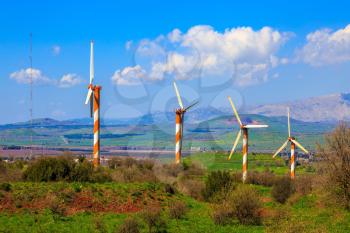 Israel. The blossoming Golan heights in a sunny day. Some huge modern windmills