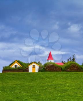 Houses are roofed by the turf and grass. Village of ancestors. The recreated village -  museum of first settlers in Iceland