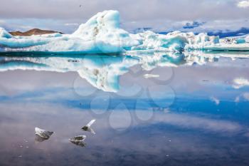 Ice splendor. Floating ice and clouds reflected in the mirror-smooth water Ice Lagoon, Iceland